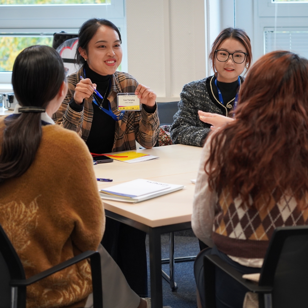 Doctoral researchers deep in discussion at the “Come Together” event.